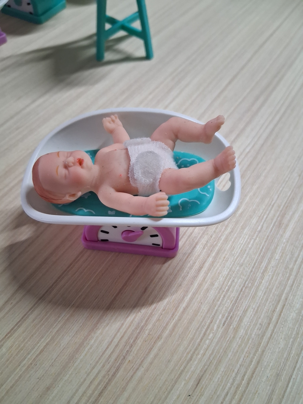 Mini Baby Doll on Teal Changing Pad and White Bath Tub